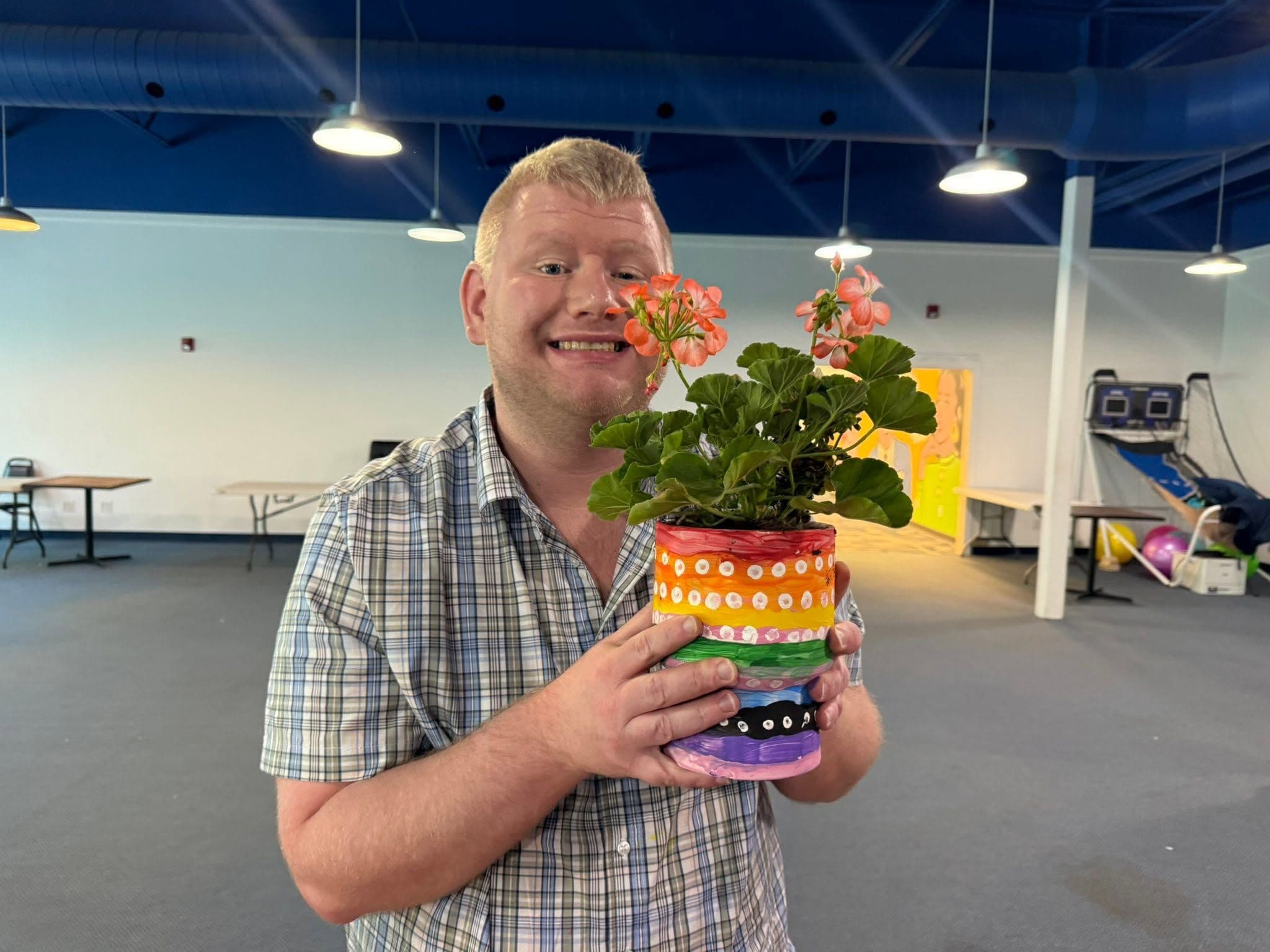 Individual holding a painted flower pot